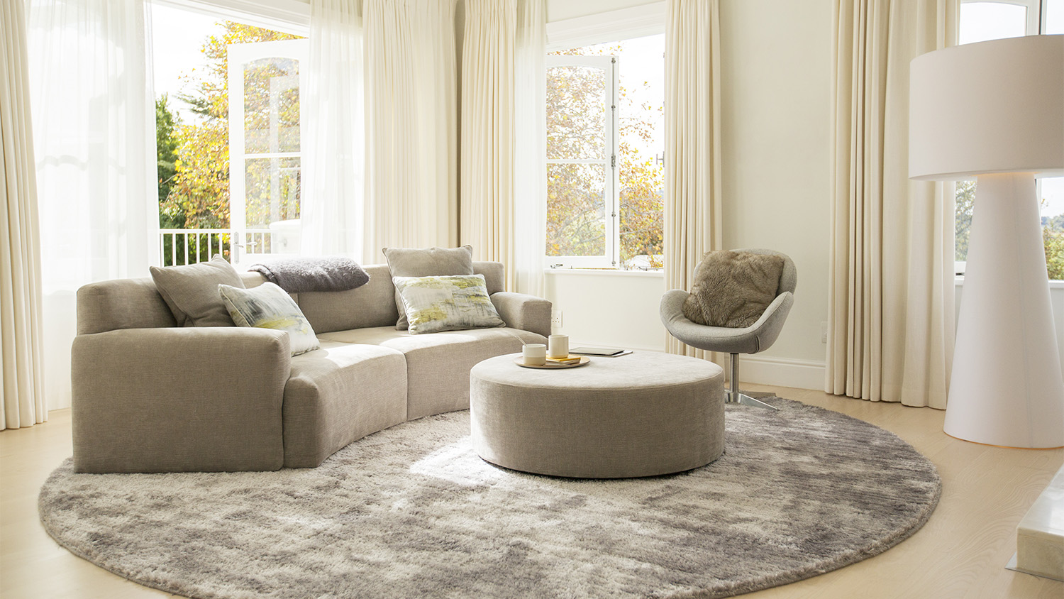 round grey sofa in bright living